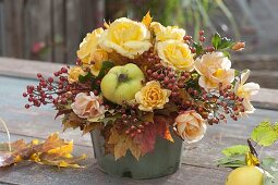 Yellow autumn bouquet with quinces (Cydonia), pinks (roses, rose hips)