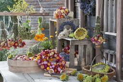 Arranged wreath, bouquets and single flowers and pot of Xerochrysum