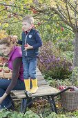 Woman with children harvesting apples