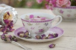 Rose tea in cup with rose decoration