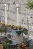 Unusual Advent wreath in coffee cups on zinc tray