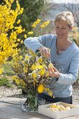 Woman decorates Easter bouquet