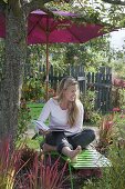 Green Liege with parasol under apple tree