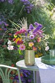 Colorful cottage's garden bouquet on the table at the aster bed