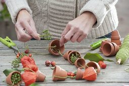 Garland made of clay pots and fruit stands as a table decoration