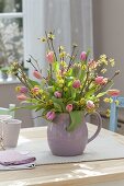 Strauss aus Cornus mas (Kornelkirsche) und Tulipa (Tulpen) in Keramik-Krug