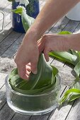 Table arrangement of corn leaves in glass bowl