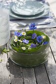 Table arrangement of corn leaves in glass bowl