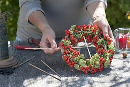 Wreath made of rowan berries, ornamental apples and stonecrop