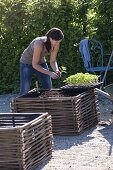 Gravel terrassse with raised beds made of hazelnut rods