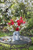 Red-white bouquet made of branches of Prunus, Malus