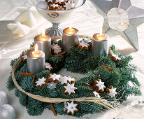 Advent wreath with fir branches, cinnamon sticks, cinnamon stars