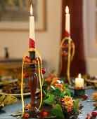 Autumnal table decoration: candle holder decorated with Malus (ornamental apples)