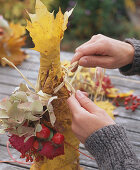 Bottle in leaf dress (5/6). Bottle with Acer (maple foliage) wrapped around it.