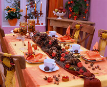Autumn table decoration with cone garland