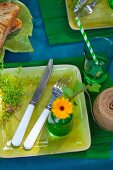 Table festively set in shades of blue and green outdoors