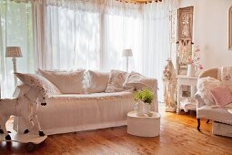 Sofa mit weisser Husse und Dekokissen in Shabby Ambiente