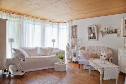 Two sofas and wooden horse in shabby-chic living room