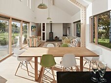 Open-plan living room in natural shades with glass wall leading to garden