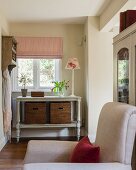 Storage baskets below vintage console table