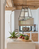 Lanterns above island counter in Mediterranean kitchen