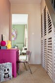 Flurbereich mit pinkfarbenem Schreibtisch und Treppenunterbau