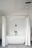 White bathtub with shower curtain in renovated period building