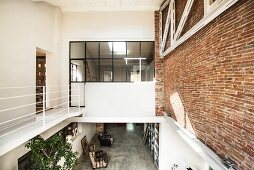 Gallery level in loft apartment with brick wall