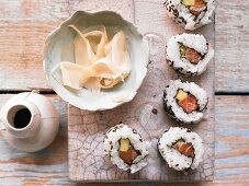 Inside-out rolls with salmon, avocado and sesame seeds