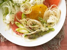 A plate of salad with fennel, citrus fruits and fried green asparagus