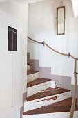 Restored wooden staircase with rope handrail