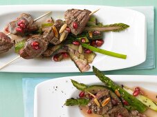 Beef kebabs on a bed of grilled vegetables with pomegranate vinaigrette