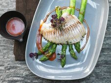 Roasted venison on red peppers with steamed green asparagus