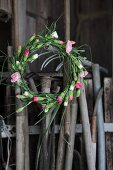 Gardening tools and wreath of carnations