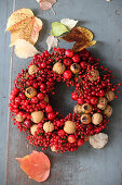 Wreath of red berries, walnuts and medlars