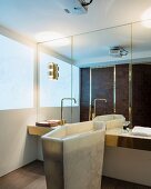 Marble pedestal sink and mirrored wall in elegant bathroom