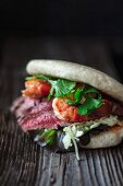 A bao burger with beef and prawns