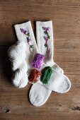 Hand-knitted woollen socks embroidered with flowers and matching wools