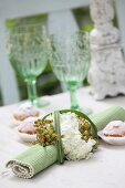 Rolled place mat with napkin ring made from flowers