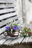 Arrangement of delphiniums and sweet Williams in metal dish