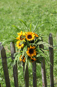 Bouquet of sunflowers on wooden fence