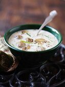 Creamy venison broth with mushrooms and dumplings