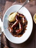 Venison sausages with onions and mashed potatoes