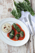 Chard rolls filled with minced meat and served with spiced rice