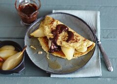 Nut pancakes with pear and chocolate sauce
