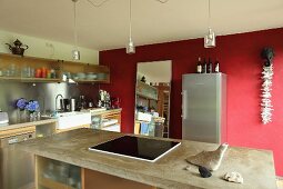 Island counter and red wall in kitchen
