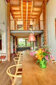 Colourful vase of flowers in dining area in front of gallery