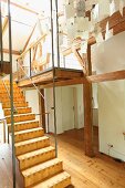 Modern wooden staircase in renovated period building with half-timbered structure