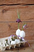 Flowers arranged in goose eggs in egg carton