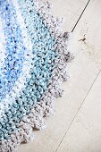 Crocheted, oval, rag-yarn rug in shades of blue